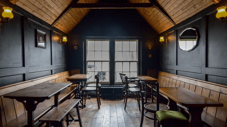 The pub half of Beerwolf Books, with wooden benches overlooking a large window